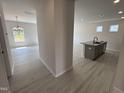 Open concept living room with a kitchen island, modern lighting, and lots of natural light at 67 Commons Cir, Clayton, NC 27520