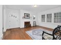 Spacious living room featuring hardwood floors, fireplace, and arched entryways at 701 E Nash St, Spring Hope, NC 27882