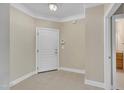 Neutral entryway featuring tile flooring, crown molding, and a white front door at 711 Providence Glen Dr, Chapel Hill, NC 27514