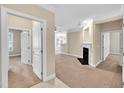 Open-concept living room with plush carpeting, fireplace, and neutral wall color at 711 Providence Glen Dr, Chapel Hill, NC 27514
