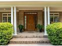 Inviting front entrance with a solid wood door and manicured greenery at 74002 Harvey, Chapel Hill, NC 27517