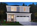 Exterior elevation of a two-story home with gray siding, brick accents, and a two-car garage at 809 Ottawa Dr, Garner, NC 27529