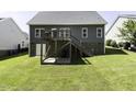 Expansive backyard with a deck and stairs, ideal for outdoor entertaining and leisure at 870 Live Oak Ln, Nashville, NC 27856