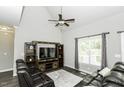 Comfortable living room featuring vaulted ceiling, ceiling fan and leather furniture at 870 Live Oak Ln, Nashville, NC 27856