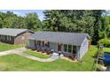 Charming single-story home with a well-maintained lawn, red shutters and matching front door at 1007 Ancroft Ave, Durham, NC 27713