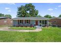 Charming single-story home with a well-maintained lawn, red shutters and matching front door at 1007 Ancroft Ave, Durham, NC 27713