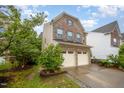 Beautiful two-story home featuring a two-car garage, brick and vinyl siding, and mature landscaping at 1030 Thoughtful Spot Ln, Durham, NC 27703