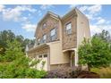 Attractive two-story home with a two-car garage, brick and vinyl siding, and well-maintained front yard landscaping at 1030 Thoughtful Spot Ln, Durham, NC 27703