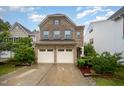 Charming two-story brick home featuring a two-car garage, manicured landscaping, and a welcoming front entrance at 1030 Thoughtful Spot Ln, Durham, NC 27703