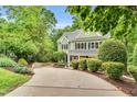 Charming two-story home with a well-manicured lawn, inviting porch, and mature landscaping at 104 Windorah Place Pl, Chapel Hill, NC 27517