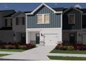 Rendering of townhome featuring blue siding, white trim, a garage, and landscaped front yard at 1043 Winding Spring Dr, Mebane, NC 27302