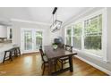 Bright dining room with hardwood floors, large windows, and modern light fixture at 106 Bluefield Rd, Chapel Hill, NC 27517