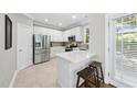 Modern kitchen with white cabinets, stainless steel appliances, and a breakfast bar with seating at 106 Bluefield Rd, Chapel Hill, NC 27517