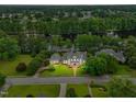 Aerial view of home on large lot with lake, lush trees and other homes in neighborhood at 1093 N Lakeside Dr, Smithfield, NC 27577