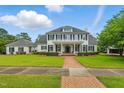 Inviting two-story home featuring a brick pathway, manicured lawn and classic black shutters at 1093 N Lakeside Dr, Smithfield, NC 27577