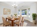 Bright dining room featuring natural light from windows, a chandelier and wood dining table at 1148 Dexter Ridge Dr, Holly Springs, NC 27540