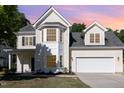 Inviting two-story home with a two-car garage, bay window and manicured lawn and yellow siding at 1148 Dexter Ridge Dr, Holly Springs, NC 27540