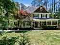 Charming two-story home featuring a welcoming front porch, well-maintained lawn, and classic design elements at 120 Harmony Hill Ln, Cary, NC 27513