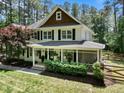 Elegant home boasting a screened-in porch, manicured landscaping, and stylish architectural details at 120 Harmony Hill Ln, Cary, NC 27513