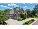 Spacious home with a large driveway, three-car garage, and lush landscaping under a bright sky at 12317 Richmond Run Dr, Raleigh, NC 27614