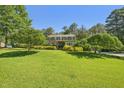 Spacious front lawn with mature landscaping and a two-story brick home at 1315 Brigham Rd, Chapel Hill, NC 27517