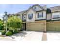 Charming townhome features a two-car garage, stone accents, and well-manicured landscaping at 140 Sunstone Dr, Cary, NC 27519