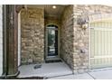Inviting front entrance with stone facade and glass-paneled door, framed by arched entryway at 140 Sunstone Dr, Cary, NC 27519