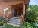 Charming front porch features natural wood finishes, greenery, and a ceiling fan at 1656 Nc-42 Hwy, Moncure, NC 27559