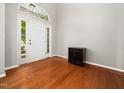 Bright foyer featuring hardwood floors, a neutral color palette, and an elegant entryway with sidelights at 1719 Willowcrest Rd, Durham, NC 27703