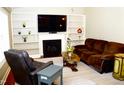 Comfortable living room with fireplace, built in shelving, and plush seating for relaxing at 1980 Ferbow St, Creedmoor, NC 27522