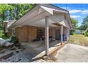 Exterior carport with brick and siding, offering covered parking and additional storage options at 2010 Summerdale Dr, Raleigh, NC 27604