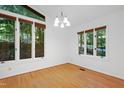Sun-filled dining area boasting hardwood floors, large windows and modern light fixture at 205 Bruton Dr, Chapel Hill, NC 27516