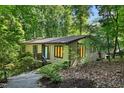 Exterior view of home featuring lush green foliage and natural light throughout at 205 Bruton Dr, Chapel Hill, NC 27516
