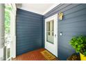 A welcoming entrance with a screen door, golden light fixture, and charming decor at 206 Lilliput Ln, Wake Forest, NC 27587