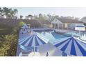 Relaxing community pool area with lounge chairs, tables, and umbrellas for residents' enjoyment at 348 Chesapeak Commons St # 137, Garner, NC 27529