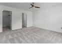 Spacious bedroom with neutral carpet, fan and two closets at 3816 Mike Levi Ct, Raleigh, NC 27610
