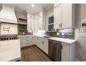 Stylish kitchen features sleek stainless steel appliances, custom white cabinetry, and modern countertops at 4009 Yates Mill Pond Rd, Raleigh, NC 27606