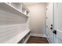 Well-organized mudroom features a bench, storage cubbies, and modern white shiplap for efficient living at 4009 Yates Mill Pond Rd, Raleigh, NC 27606
