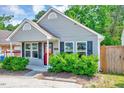 A lovely one-story home exhibits great curb appeal with its manicured lawn and inviting entryway at 4114 Sudbury Rd, Durham, NC 27704
