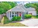 Attractive one-story home with pleasing exterior paint, dark shutters, and lush greenery at 4114 Sudbury Rd, Durham, NC 27704