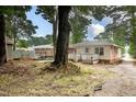 Spacious backyard featuring a patio, mature trees, and ample space for outdoor activities at 420 Peyton St, Raleigh, NC 27610