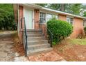 Inviting entrance with steps, wrought iron railing, and a classic brick pathway at 420 Peyton St, Raleigh, NC 27610