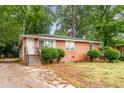 Traditional brick home featuring a welcoming front entrance with stairs and mature trees at 420 Peyton St, Raleigh, NC 27610