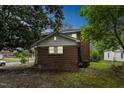 Home with a brick and white siding featuring windows and mature trees at 500 Cokey Rd, Rocky Mount, NC 27801