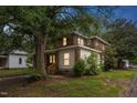 Home with a brick and white siding featuring windows and mature trees at 500 Cokey Rd, Rocky Mount, NC 27801