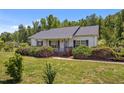 Traditional single story home offers a cozy front porch and well manicured lawn at 5013 W Pool Rd, Rougemont, NC 27572