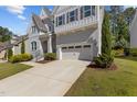 Beautiful home with a long driveway leading to an attached two-car garage and landscaped front yard at 5145 Landguard Dr, Raleigh, NC 27613