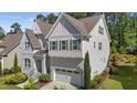 Two story home with painted brick and siding, an attached two-car garage, and well-maintained landscaping at 5145 Landguard Dr, Raleigh, NC 27613