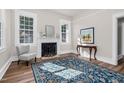 Bright living room featuring a fireplace, large windows, and stylish decor with a patterned area rug at 5299 Momeyer Way, Nashville, NC 27856