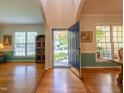 Inviting foyer with hardwood floors and an open view to the living and dining spaces at 5417 Harrington Grove Dr, Raleigh, NC 27613